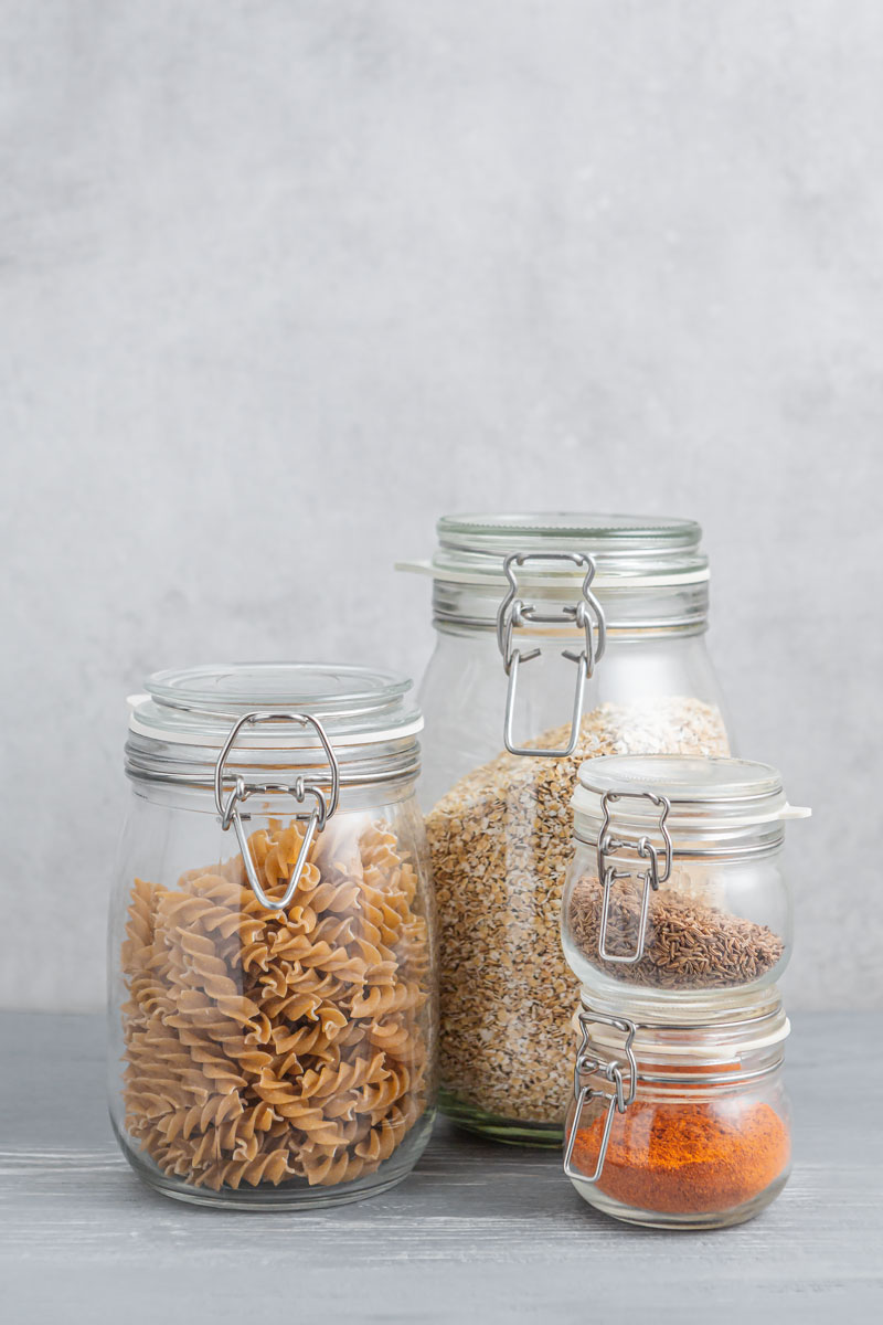 Verschiedenen Vorratsgläser mit Gewürzen, Pasta und Haferflocken